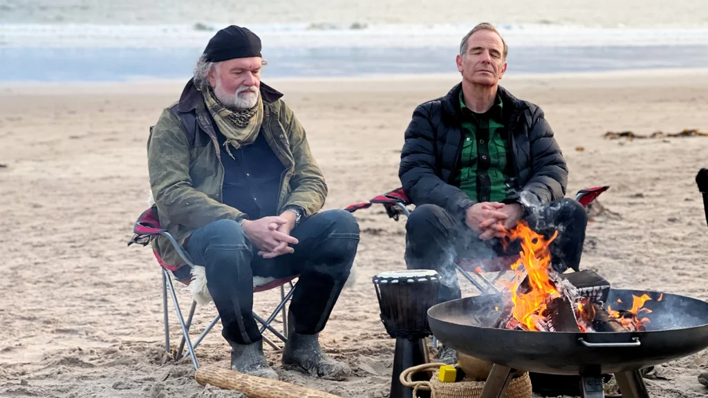 Robson Green and Si King relaxing on the beach around a camp fire