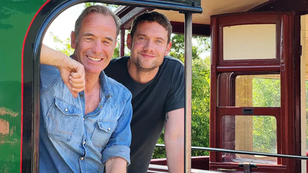 Robson Green and Tom Brittney standing on a steam train