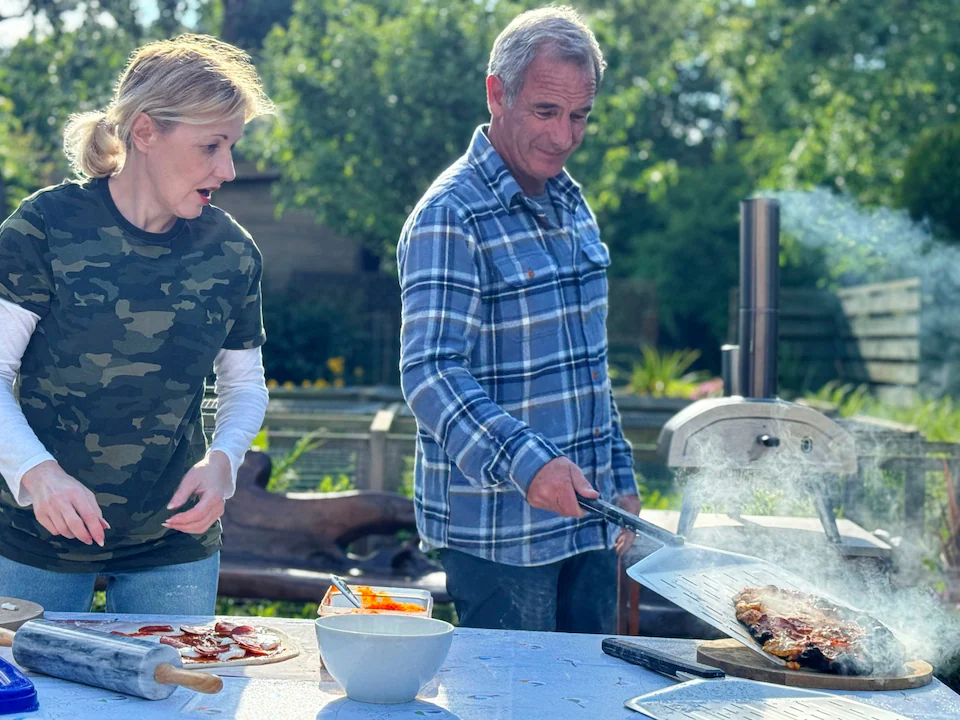 Kacey Ainsworth and Robson making pizzas on Robson Green’s Weekend Escapes