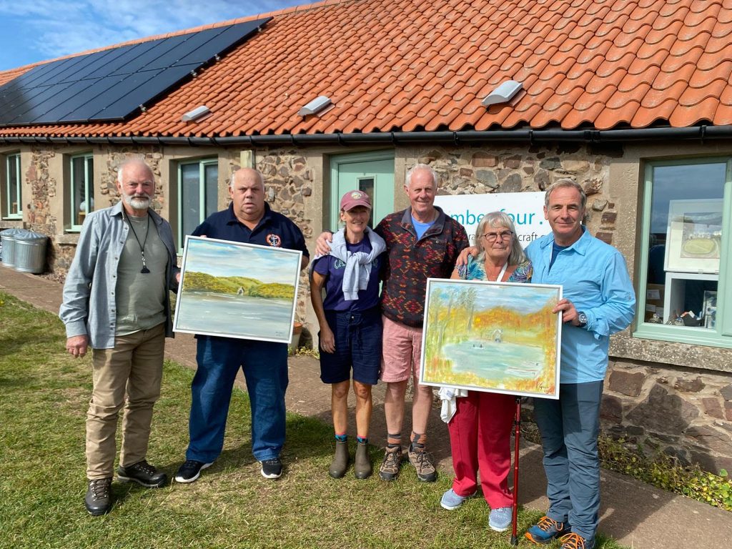 Robson and Matheson handing over the paintings