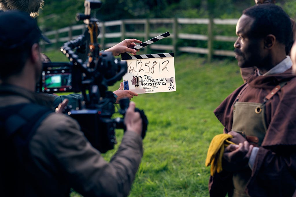 Behind the camera view and clapper board